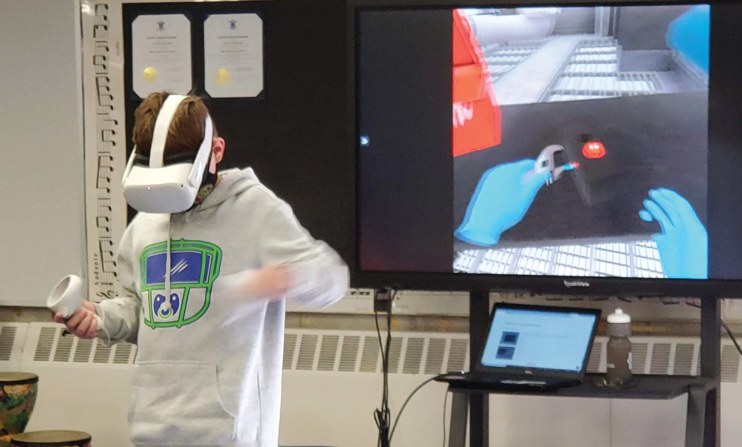 THE OTHER VIRTUAL LEARNING: A Scituate student adjusts a machine in a virtual reality environment. The Scituate Career & Technology Education program uses virtual reality and GIS technology to help students explore potential career options.